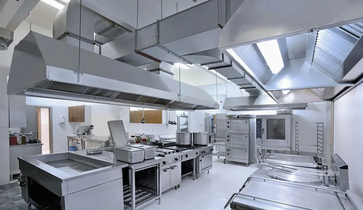 Commercial kitchen with stainless steel exhaust hoods and ductwork